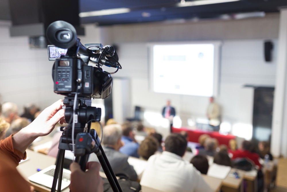 Business Conference and Presentation. Audience at the conference hall. Television broadcasted press conference.